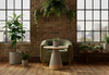 Byorne Side Table by Quell Design placed in a bright contemporary room with exposed brick walls, oak floors, large windows, and lush greenery. Featuring a soft oval white oak top and mocha-toned rounded base, this sculptural side table blends natural warmth with minimalist Scandinavian design. Crafted from eco-friendly materials, it brings refined simplicity and balance to modern living and lounge spaces.