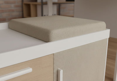 Moda Cabinet Cushion Top on the Moda Mobile Storage Cabinet in an office interior with exposed brick walls and wooden flooring, showcasing a modern workspace seating solution with linen upholstery and ergonomic cushioning.