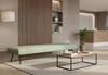 The Omni Collaborative Soft Seating Bench is a modern office furniture piece. This long dusty teal upholstered bench sits centrally on a light rug in a contemporary office reception area. It suits flexible working, informal collaboration and waiting areas in open lounges and breakout spaces. The bench helps create a productive workplace.