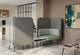 An Omni Dual-Facing Acoustic Seating unit, a modular workspace solution, features two corner seating units upholstered in dusty teal and pebble grey, enhancing acoustic comfort in a modern open-plan office. Integrated dark grey acoustic privacy panels define each zone, complemented by a low table with integrated power outlets. An additional freestanding acoustic panels adds to this flexible workspace design, ideal for focused work, informal collaboration and creating defined work zones.